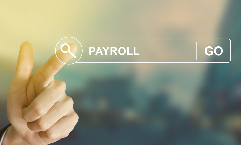 person touching a button that says payroll