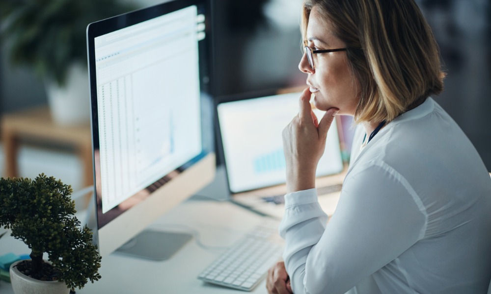 woman looking at a self-service portal on a computer at work